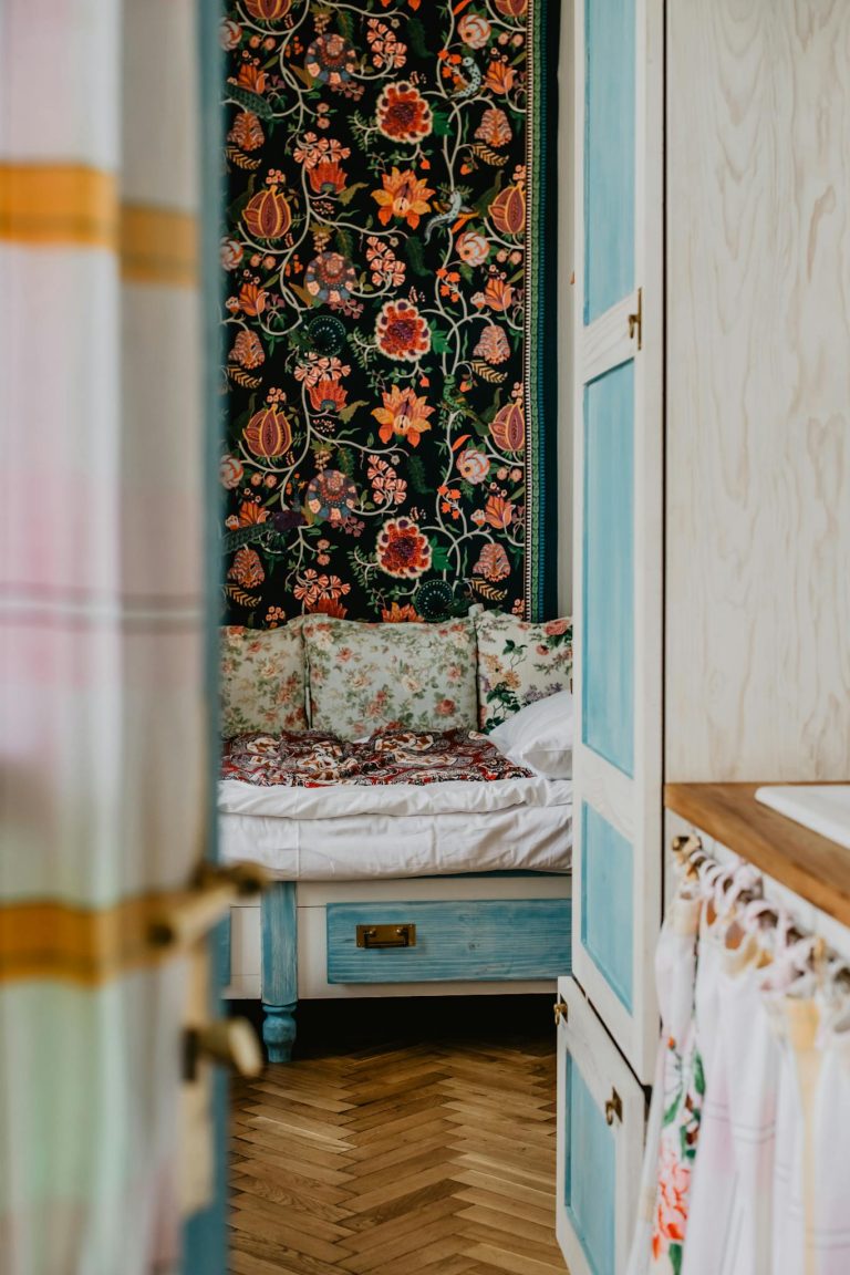 Inviting bedroom interior featuring vintage floral decor and cozy atmosphere.