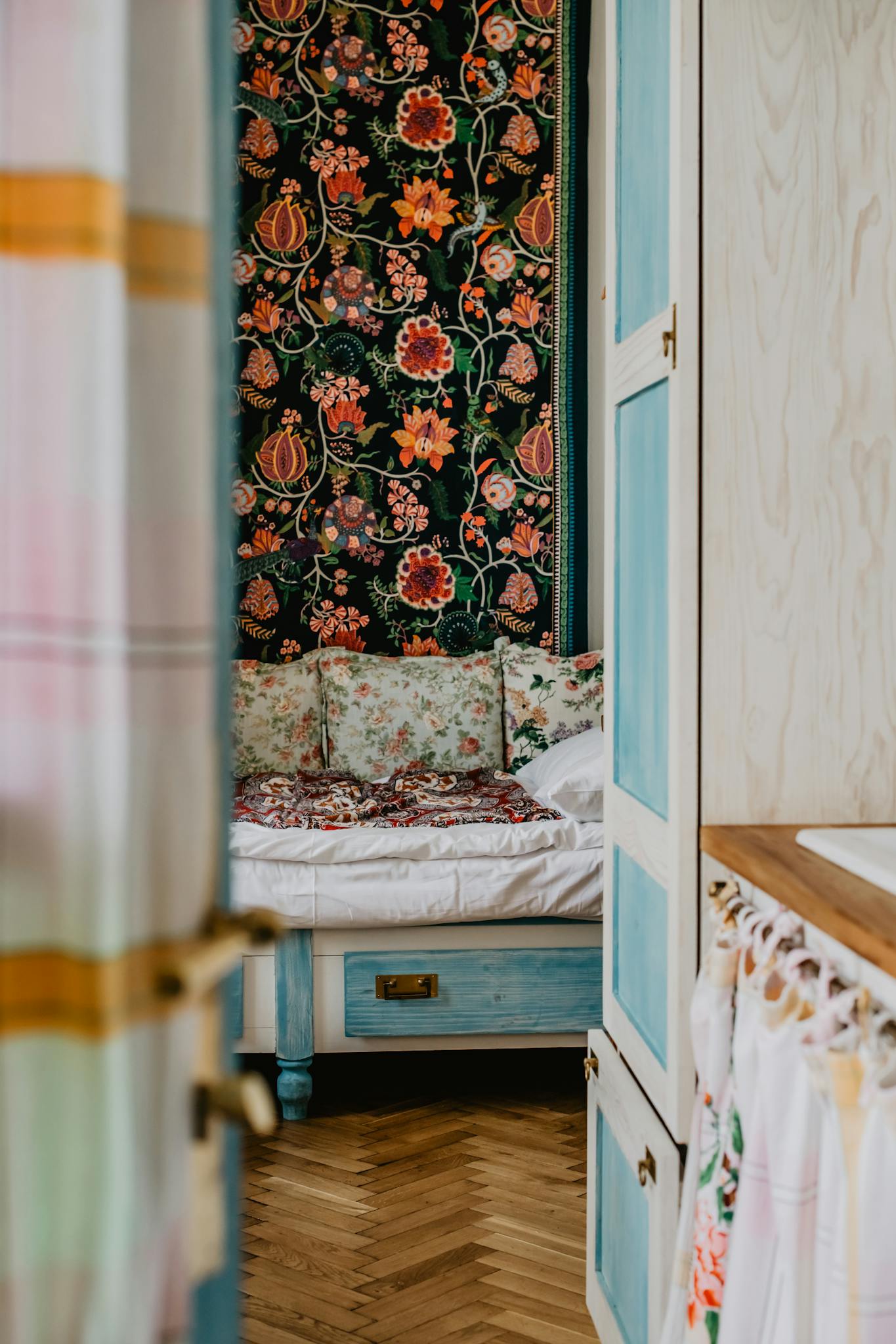Inviting bedroom interior featuring vintage floral decor and cozy atmosphere.